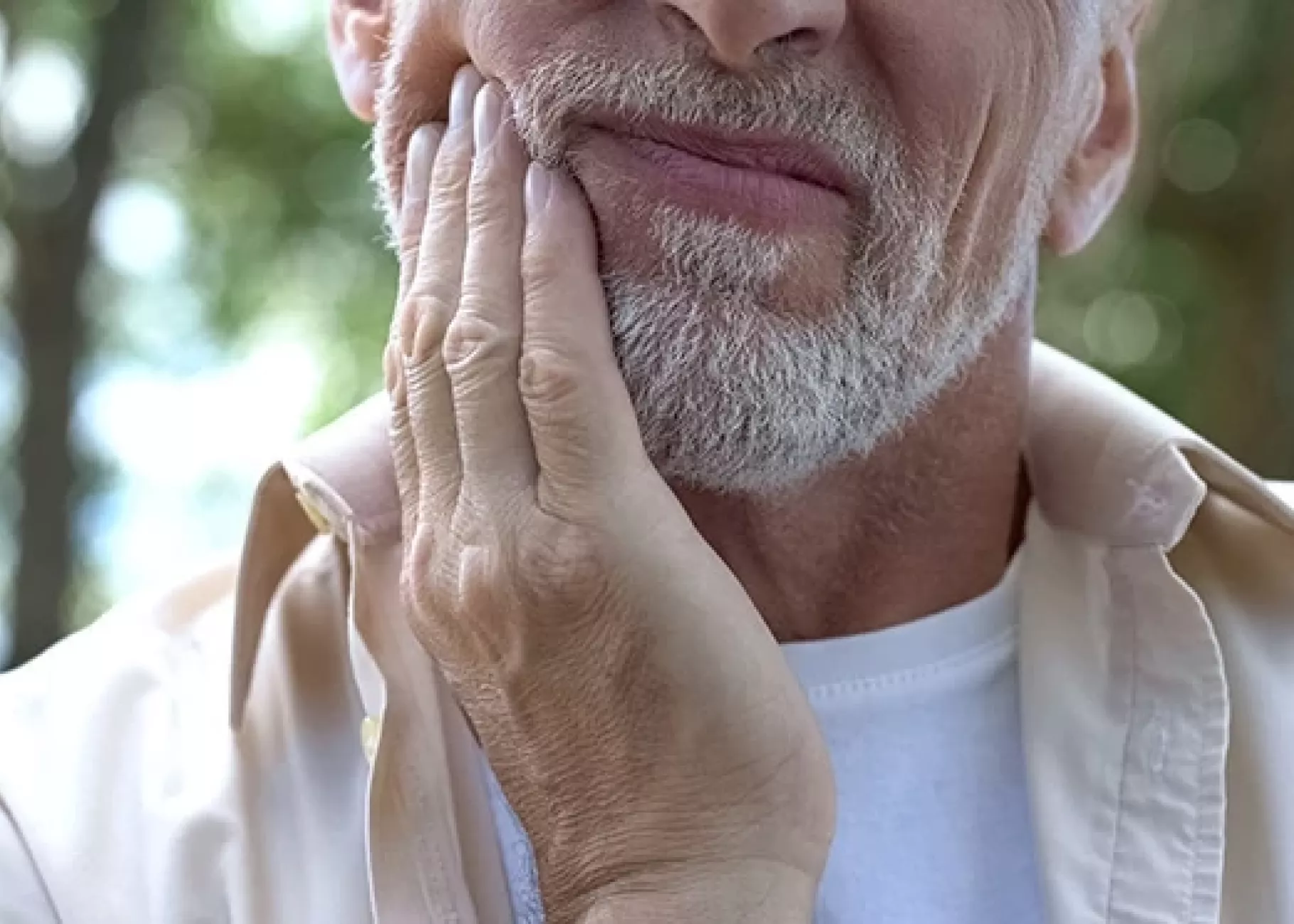 Older man holding jaw