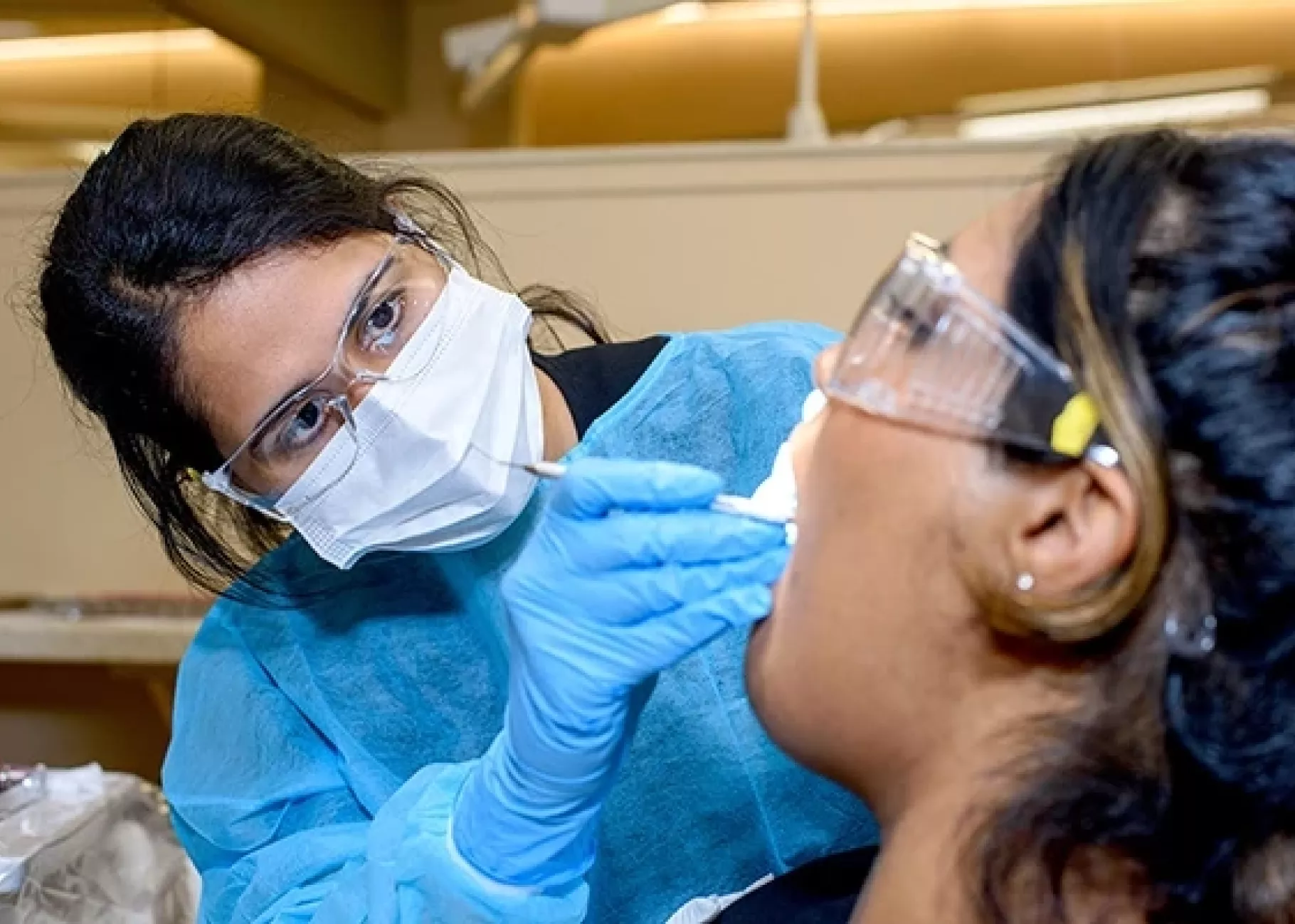 Dental student working in patient's mouth