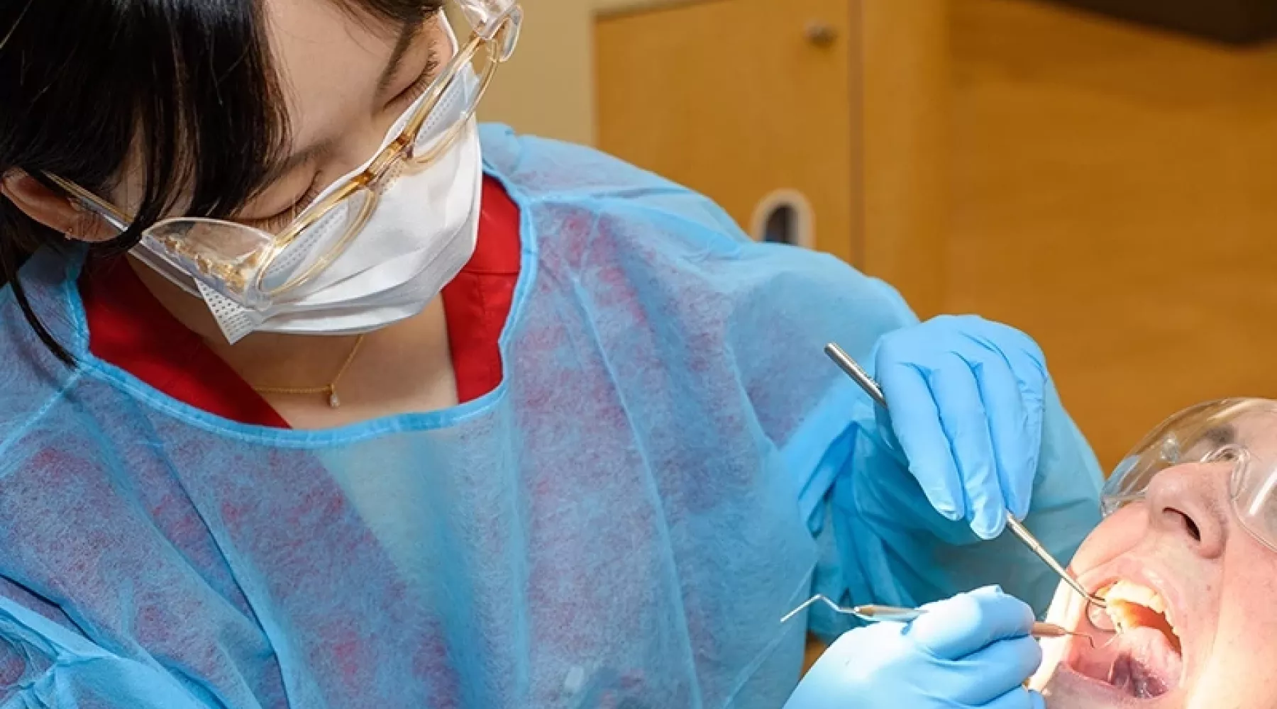 Dental student works in a patient's mouth